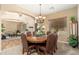 Spacious dining room with large windows, wooden table, seating for eight and stylish accents at 1074 E Carla Vista Ct, Gilbert, AZ 85295
