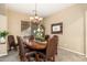Stylish dining room with wood table, seating for six, and modern chandelier fixture at 1074 E Carla Vista Ct, Gilbert, AZ 85295