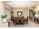 Elegant dining room featuring a large wood table, six chairs, and a charming chandelier at 1074 E Carla Vista Ct, Gilbert, AZ 85295
