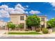 Attractive two-story home featuring desert landscaping, palm trees and a manicured lawn at 1074 E Carla Vista Ct, Gilbert, AZ 85295