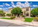 Inviting two-story home boasts mature trees, lush landscaping, and charming curb appeal at 1074 E Carla Vista Ct, Gilbert, AZ 85295