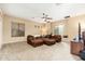 Expansive living room with plush sectional sofa, ceiling fan, and neutral carpeting at 1074 E Carla Vista Ct, Gilbert, AZ 85295