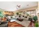 Open-concept living space with hardwood floors, neutral decor, and a comfortable sectional sofa at 1074 E Carla Vista Ct, Gilbert, AZ 85295