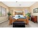 Spacious main bedroom with a large wood bed, bedside tables, and a sitting bench at 1074 E Carla Vista Ct, Gilbert, AZ 85295