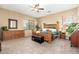 Spacious main bedroom with a large window, ceiling fan, carpet floors, and an ensuite bathroom at 1074 E Carla Vista Ct, Gilbert, AZ 85295