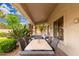Covered patio with a dining table, chairs, desert landscaping, string lights and a blue sky overhead at 1074 E Carla Vista Ct, Gilbert, AZ 85295