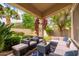Covered patio with a seating area, desert landscaping, string lights and a blue sky overhead at 1074 E Carla Vista Ct, Gilbert, AZ 85295