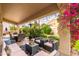 Covered patio with a dining table, seating area, desert landscaping, string lights and a blue sky overhead at 1074 E Carla Vista Ct, Gilbert, AZ 85295