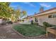 Lush backyard with a well-manicured lawn, BBQ, desert landscaping, and refreshing pool at 10809 N 111Th Pl, Scottsdale, AZ 85259