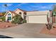 Two-car garage, desert landscaping, and charming single-story home with a red-tile roof at 10809 N 111Th Pl, Scottsdale, AZ 85259