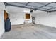 Large, well-lit garage with ample storage space, shelving, and a clean epoxy-coated floor at 10809 N 111Th Pl, Scottsdale, AZ 85259