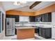 Updated kitchen features stainless steel appliances, granite counters, breakfast bar, and sleek dark cabinets at 10809 N 111Th Pl, Scottsdale, AZ 85259