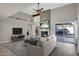 Elegant living room with fireplace, contemporary furnishings, and seamless access to the backyard at 10809 N 111Th Pl, Scottsdale, AZ 85259