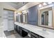 Well-lit main bathroom featuring dual sinks, vanities, and ample storage with large mirrors at 10809 N 111Th Pl, Scottsdale, AZ 85259
