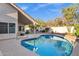 Inviting backyard pool perfect for relaxation with a covered patio and lush landscaping at 10809 N 111Th Pl, Scottsdale, AZ 85259