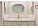 Modern bathroom featuring a quartz countertop, gold faucet, and stylish oval mirror at 110 S 72Nd Way, Mesa, AZ 85208