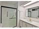Modern bathroom with sleek black shower enclosure, quartz counters, and gold hardware at 110 S 72Nd Way, Mesa, AZ 85208