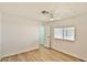 Bedroom with light wood floors and a ceiling fan, looking out to the large yard at 110 S 72Nd Way, Mesa, AZ 85208