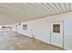 Spacious covered carport with white siding and a door leading to storage at 110 S 72Nd Way, Mesa, AZ 85208