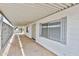 Covered carport with white siding, gray window trim, and a concrete floor at 110 S 72Nd Way, Mesa, AZ 85208
