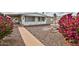 Charming home featuring a well-maintained front yard, water fountain, and gorgeous pink bougainvillea at 110 S 72Nd Way, Mesa, AZ 85208