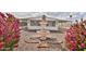 Charming home featuring a well-maintained front yard, beautiful water fountain, and gorgeous pink bougainvillea at 110 S 72Nd Way, Mesa, AZ 85208