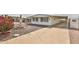Charming home featuring a well-maintained front yard, beautiful water fountain, and covered parking at 110 S 72Nd Way, Mesa, AZ 85208