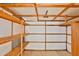 Clean and unfinished storage space with wood framing, shelving, and concrete flooring at 110 S 72Nd Way, Mesa, AZ 85208