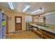 Large storage area with shelving, overhead lighting, and laminate flooring at 110 S 72Nd Way, Mesa, AZ 85208