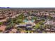 Expansive aerial view of the community clubhouse, pool, tennis courts, and desert landscaping at 11736 E Del Timbre Dr, Scottsdale, AZ 85259