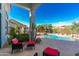 Outdoor seating area showcases the pool, lush landscaping, and brilliant blue skies at 11736 E Del Timbre Dr, Scottsdale, AZ 85259