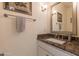 Powder bath features a decorative framed mirror and marble countertop vanity sink at 11736 E Del Timbre Dr, Scottsdale, AZ 85259