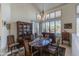 Inviting dining room boasting neutral decor, plantation shutters, stylish chandelier and beautiful furniture pieces at 11736 E Del Timbre Dr, Scottsdale, AZ 85259