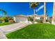 Charming single-story home featuring a well manicured lawn, beautiful palm trees, and an attached two-car garage at 11736 E Del Timbre Dr, Scottsdale, AZ 85259