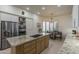 Spacious eat-in kitchen with granite countertops, stainless steel appliances, and modern lighting at 11736 E Del Timbre Dr, Scottsdale, AZ 85259