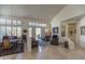 Spacious living room featuring neutral decor, plantation shutters, fireplace, and seamless access to the outdoors at 11736 E Del Timbre Dr, Scottsdale, AZ 85259