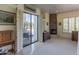 Living room featuring a stone fireplace, neutral colors, and access to the outdoor pool area at 11736 E Del Timbre Dr, Scottsdale, AZ 85259