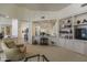 Open-concept living room featuring beautiful decor, built-in shelving, and seamless transition to the kitchen at 11736 E Del Timbre Dr, Scottsdale, AZ 85259