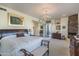 Bright main bedroom featuring a stone fireplace, chandelier, and a private outdoor patio at 11736 E Del Timbre Dr, Scottsdale, AZ 85259
