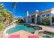 Inviting backyard pool and spa area complete with rock waterfall and lush landscaping at 11736 E Del Timbre Dr, Scottsdale, AZ 85259
