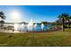 Beautiful lake featuring fountains and lush landscaping in a vibrant community at 12031 S 184Th Ave, Goodyear, AZ 85338