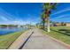 Scenic waterfront path lined with palm trees and fountains in a well-kept community at 12031 S 184Th Ave, Goodyear, AZ 85338