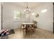 Inviting dining area features natural light, chandelier and modern furnishings at 12031 S 184Th Ave, Goodyear, AZ 85338