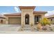 Charming home featuring desert landscaping, a barrel tile roof, and a stone entrance at 12031 S 184Th Ave, Goodyear, AZ 85338