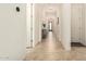 Bright hallway with decorative lighting and neutral tile flooring at 12031 S 184Th Ave, Goodyear, AZ 85338