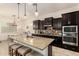 Kitchen featuring dark cabinets, granite countertops, and pendant lighting at 12031 S 184Th Ave, Goodyear, AZ 85338