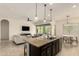 Bright kitchen with granite island, modern lighting, open to living room and dining area at 12031 S 184Th Ave, Goodyear, AZ 85338