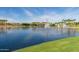 Scenic pond with fountains, trees, and green grass at 12031 S 184Th Ave, Goodyear, AZ 85338