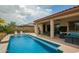 Inviting outdoor space with a pool, covered patio, dining area, and comfortable seating at 12031 S 184Th Ave, Goodyear, AZ 85338