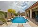 Sparkling pool surrounded by lush landscaping, a covered patio and comfortable loungers at 12031 S 184Th Ave, Goodyear, AZ 85338